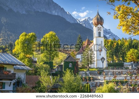 Grainau Church at golden autumn sunrise and Zugspitze massif, Bavarian alps , Germany