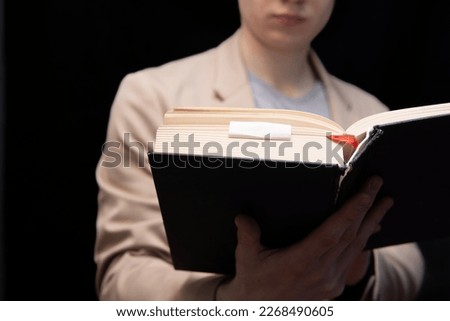 hardworking student the student learns by reading a book. Exam preparation Royalty-Free Stock Photo #2268490605