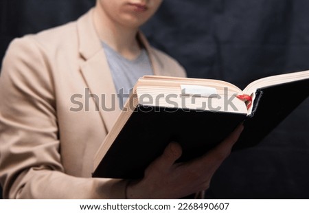 hardworking student the student learns by reading a book. Exam preparation Royalty-Free Stock Photo #2268490607