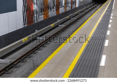 Yellow warning lines on a subway or train station platform. Safety systems in urban pedestrian traffic
