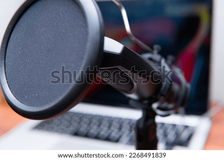 close-up of a studio microphone on a desk. Concept showing sound or podcast recording.