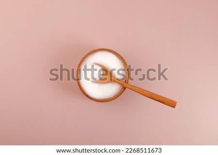  Sugar substitute Xylitol or birch sugar in wooden bowl, top view. Food additive E967, sweetener, moisture-retaining agent, stabilizer and emulsifier. Xylitol prevents dental cavities. Royalty-Free Stock Photo #2268511673