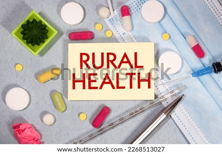 In the notebook is the text rural health, next to a stethoscope, pills and glasses.
