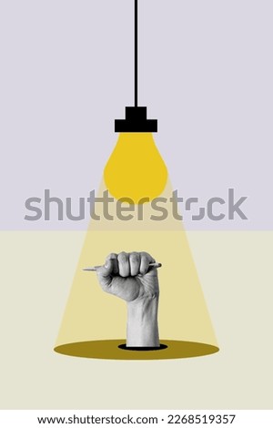 Art collage, Light from a light bulb falls on a hand with a ballpoint pen in a fist on a light background. The concept of the idea in the writing.