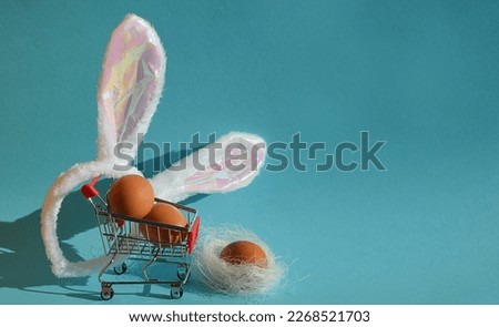 chicken eggs in a grocery cart, shopping and rabbit ears. Happy Easter. preparation for the spring holiday. background for the design.