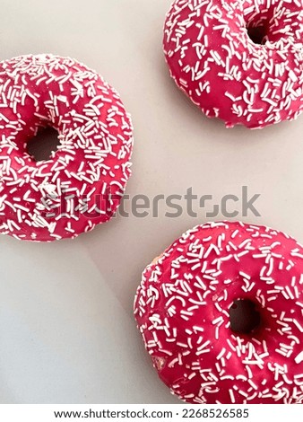 Bright pink donuts on a gray background