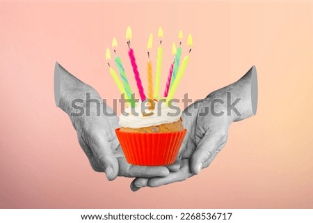 Human hand holding a sweet tasty cupcake with candle.