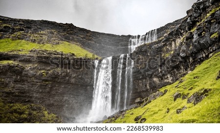 The Fossá Waterfall on Streymoy, Faroe Islands, Denmark. The water is falling a few cascades down to the fjord. 