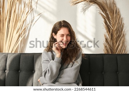 Happy wink woman blogger talking to webcam recording vlog social media influencer streaming home video call Royalty-Free Stock Photo #2268544611