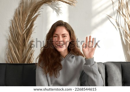 Happy woman blogger smiling waving hand talking to webcam recording vlog social media influencer streaming home video call. Head portrait