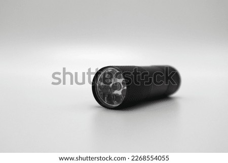 Flashlight with UV light can be used for checking banknotes cracked glass as well as inspecting insects mold and water damage Royalty-Free Stock Photo #2268554055