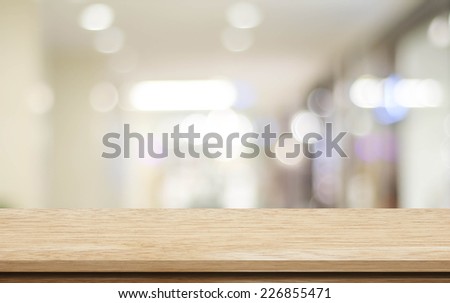 Table, counter at store, background for product display template, Empty wood desk, shelf, counter over blur retail shop with abstract bokeh light background, Wooden table top and blur store backdrop Royalty-Free Stock Photo #226855471