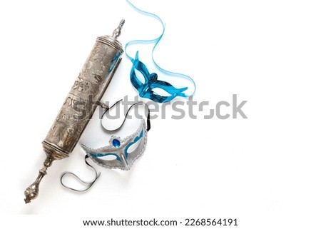 The Scroll of Esther (With an inscription in Hebrew "Book of Esther") and Purim Festival objects. On white background. Top view