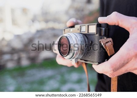 Man with retro photo camera Fashion Travel Lifestyle outdoor nature background
