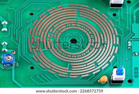 Changeover switch integrated in PCB copper layer, on-off button or resistor trimmer. Closeup of electronic components and range selector directly in green printed circuit board from multimeter inside. Royalty-Free Stock Photo #2268572759