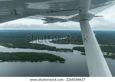 Beautiful aerial view to large river and green Amazon Rainforest