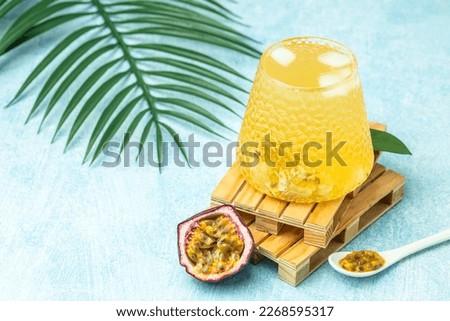 healthy drink glass of Iced passion fruit soda in a light sunny background, Tropical drink for summer party.