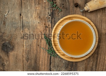 Bone broth made from pork knuckle in bowl. banner, menu, recipe place for text, top view.