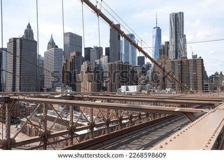 New York City skyline seen from the Brooklyn Bridge on a sunny day