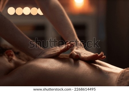 Masseuse applying hard pressure into sore muscles of female client Royalty-Free Stock Photo #2268614495