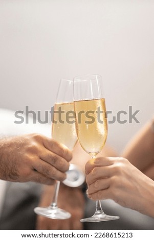 Couple toasting champagne glasses. Anniversary celebration
