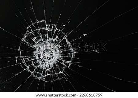 cracks on the glass impact on the glass, abstract background broken window damage Royalty-Free Stock Photo #2268618759