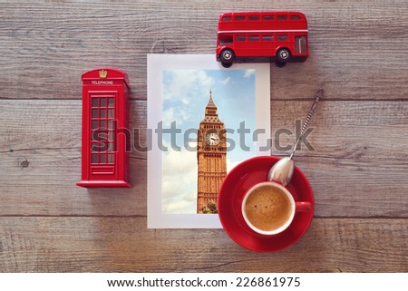 Photo of Big Ben in London on wooden table with coffee cup and souvenirs