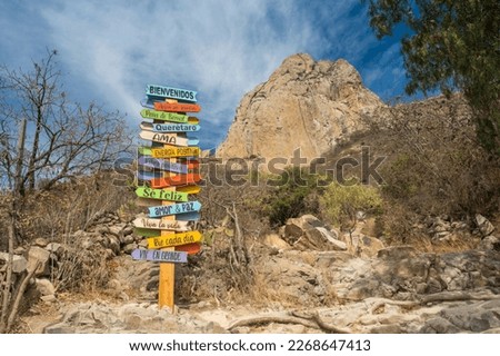 Landscape from below Peña de Bernal with different signs of emotions. adventure and exploration concept Royalty-Free Stock Photo #2268647413