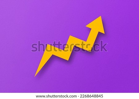 graph paper yellow arrows isolated on purple paper background Royalty-Free Stock Photo #2268648845