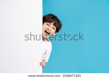 Asian boy portrait on blue background Royalty-Free Stock Photo #2268671365