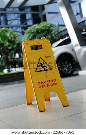 slippery yellow sign at apartment in Jakarta          