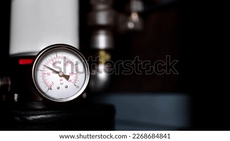 pressure gauge meter installed on air pump in factory. Royalty-Free Stock Photo #2268684841