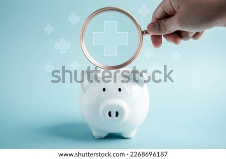 Piggy bank money health check concept. Health care financial checkup and saving for medical insurance cost planning in the future. Royalty-Free Stock Photo #2268696187