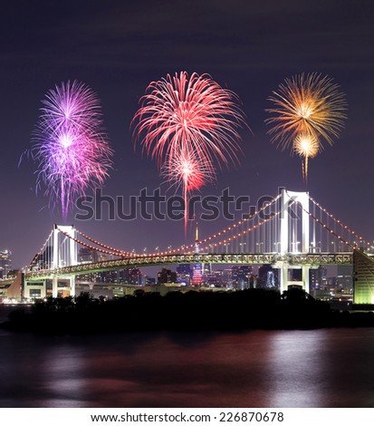 Fireworks celebrating over Tokyo Rainbow Bridge at Night, Odaiba, Japan