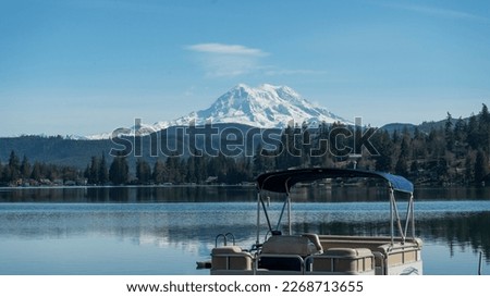 Clear lake and pontoon boat with Mount Rainier, Washington landscape in winter Royalty-Free Stock Photo #2268713655