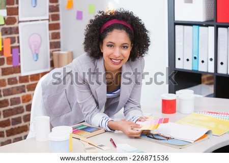 Portrait of female interior designer at office desk