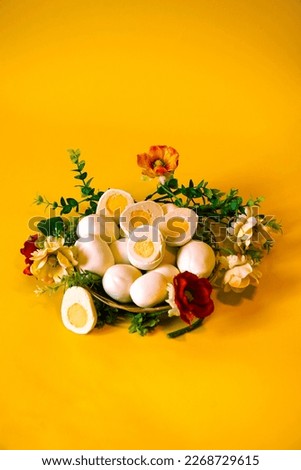 Easter picture with handmade eggs on a yellow background in a basket with flowers. spring mood. Baking in the form of Easter eggs is an interesting alternative to Easter cake. Religious holiday