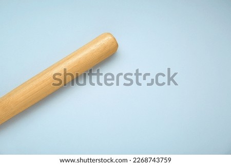 Wooden baseball bat on light grey background, top view. Space for text