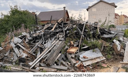 Demolition of a house built of wood. A big pile of garbage and scrap metal stock photo
