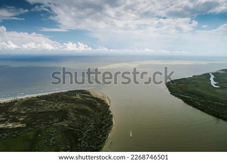 Danube river merge point with Black sea. Aerial view over this iconic landscape from Danube Delta in Sfantu Gheorghe, Romania.