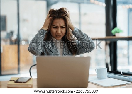 Portrait of business owner, woman using computer and financial statements Anxious expression on expanding the market to increase the ability to invest in business. Royalty-Free Stock Photo #2268753039