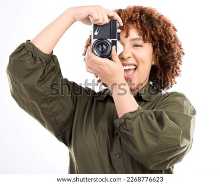 Fun, photo and portrait of a black woman with a camera isolated on a white background in a studio. Excited, professional and photographer filming, shooting and being paparazzi with equipment