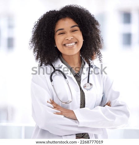 Doctor, black woman and smile portrait for healthcare with life insurance in hospital for wellness. Face of happy medical professional with arms crossed with pride for career, motivation and medicine Royalty-Free Stock Photo #2268777019
