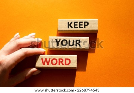 Keep your word symbol. Wooden blocks with words Keep your word. Beautiful orange background. Businessman hand. Business and Keep your word concept. Copy space.