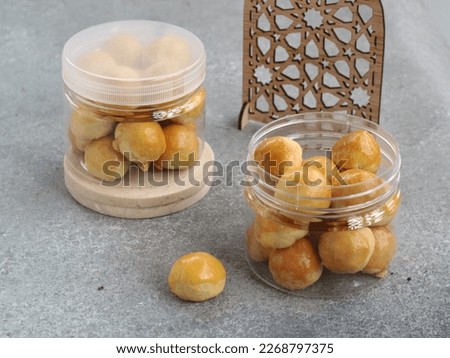 nastar or pineapple tart cookies on jar. These cookies are rich buttery shortcrust pastry with homemade sweet pineapple jam as the filling, usually popular in lebaran (eid mubarak). selected focus  Royalty-Free Stock Photo #2268797375