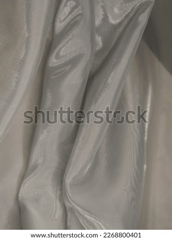 Grey shiny fabric with pleats