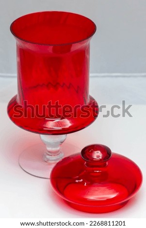 red glass decanter with its lid removed