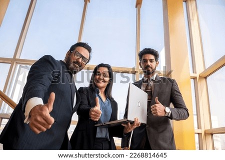Indian businesspeople showing thumps up at office. Royalty-Free Stock Photo #2268814645