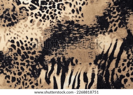 Animal mixed leopard and zebra print on elastic fabric as background. Abstract wild animal print knitwear sample.