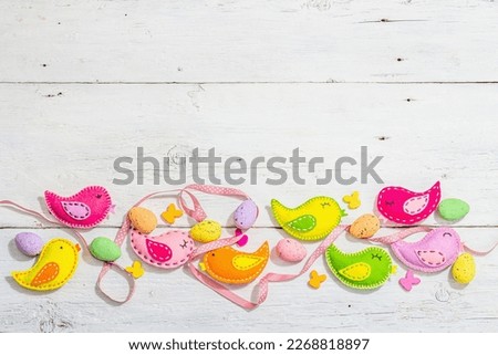 Beautiful Easter background with traditional decor. Decorative eggs, birds and rabbits. Modern hard light, dark shadow, white boards, flat lay, top view